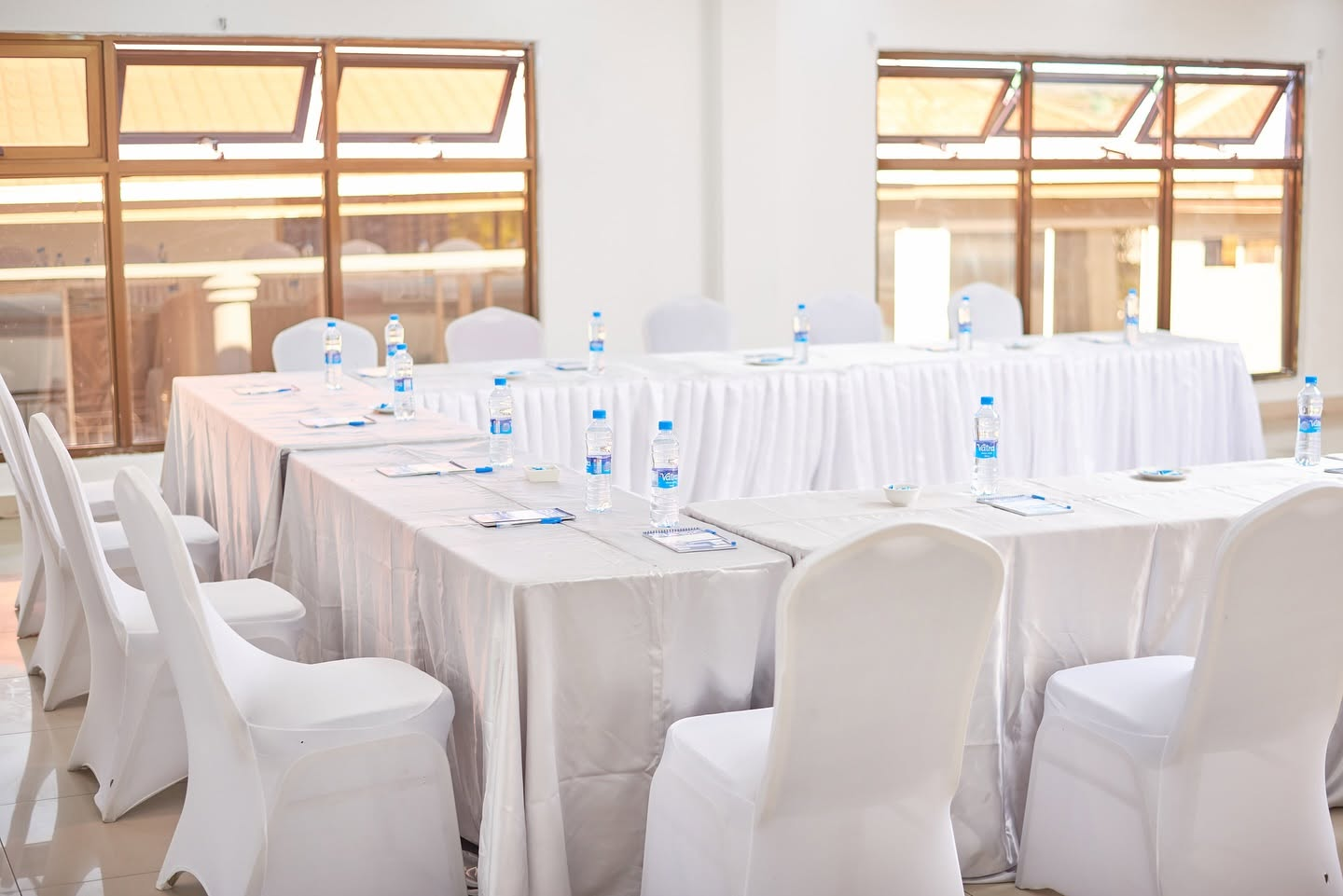 Bright conference room with white table setting